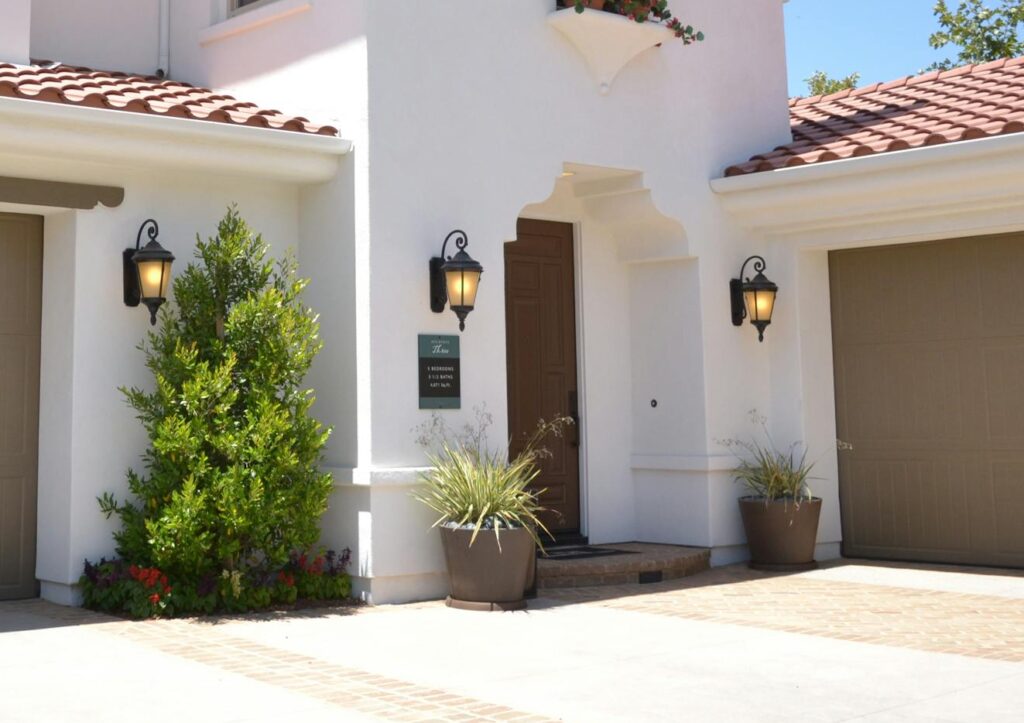 Bright suburban home with classic architecture and landscaped garden, ideal for real estate listings.