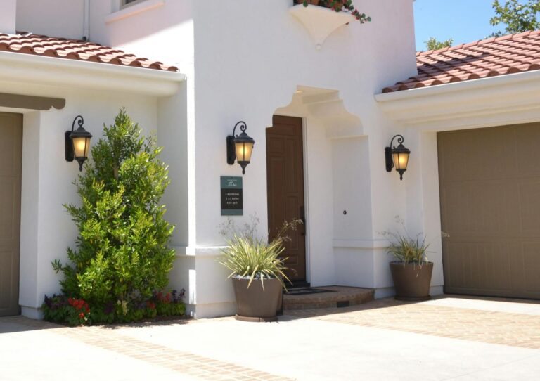 Bright suburban home with classic architecture and landscaped garden, ideal for real estate listings.